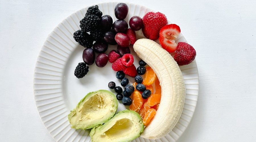 a white plate topped with fruits and vegetables